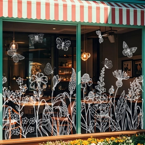 White floral and butterfly static window stickers on a glass restaurant storefront