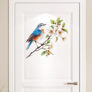 Detailed view of a colorful bird and white flower wall sticker on a white door