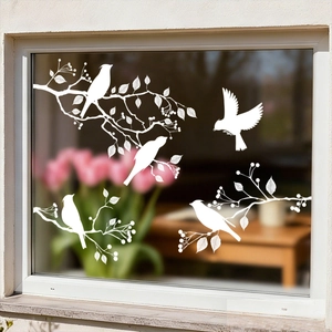Detail of white bird and tree branch silhouette static window clings on glass surface