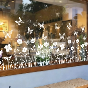 Detailansicht weißer Blumen- und Schmetterling-Fensteraufkleber auf Glasflächen