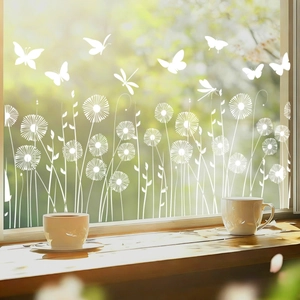 Detailed view of white dragonfly and dandelion window stickers with garden sunlight effect