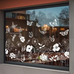 White butterfly and flower static glass decals displayed on a cafe window background