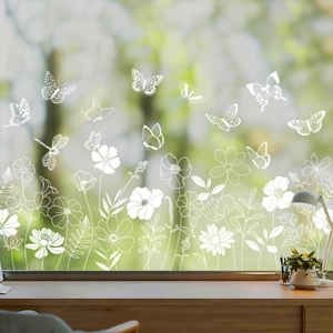 Detailed white line floral and butterfly static window stickers on a bright glass pane
