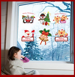 Detail of Christmas window clings featuring Santa, reindeer, and snowman cartoon decals