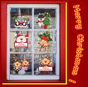 Detailed view of Merry Christmas window stickers featuring Santa, penguin and reindeer