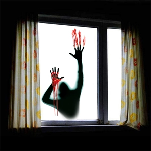 Detail of Halloween window sticker featuring a creepy shadow silhouette and bloody handprints