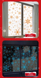 Detail view of orange and sky blue snowflake static stickers on a glass window