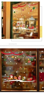 Detail of Christmas Santa Claus train window stickers on glass with festive snowflake accents
