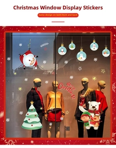 Close-up of Santa Claus and Christmas tree window stickers on retail glass displays