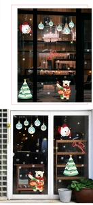 Detail of Santa Claus and Christmas tree window stickers on a store glass pane