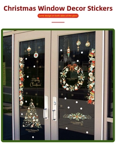 Detail of Merry Christmas window decals with festive tree and snowflake decorations