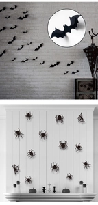 Detailed 3D Halloween wall stickers showing black spiders and bats on a grey brick wall