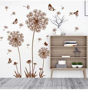 Detail of dark brown dandelion and butterfly wall stickers on a clean white wall