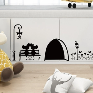 Detail of cute mouse silhouette wall stickers with street lamp and bench on white cabinet
