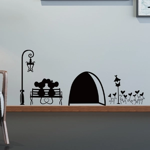 Detail of cute mouse couple silhouette wall decals on a gray wall near a wooden shelf