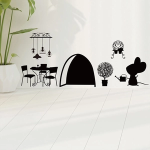 Detail of cute mouse silhouette wall stickers with table, chairs and plants on white wall