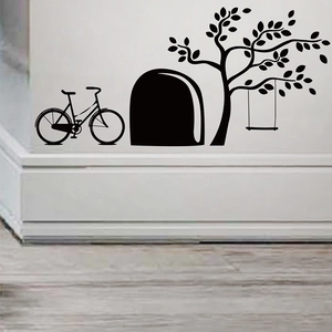 Detail of cute mouse hole wall stickers with bicycle and tree silhouette on baseboard