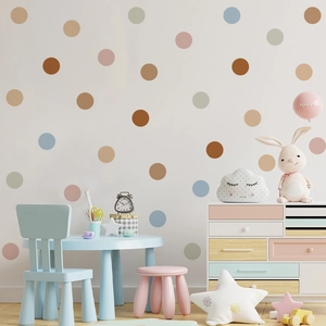 Detailed view of Morandi polka dot wall decals applied in a cozy nursery room setting