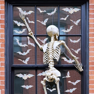 Halloween suncatcher window clings with iridescent bats and life-size skeleton decor