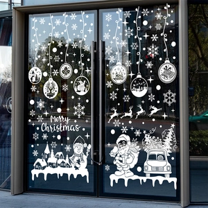 White Christmas window decals featuring Santa, reindeer and snowflakes on glass