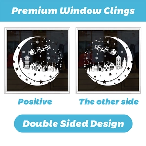 Detail of double sided Christmas window clings with white Santa and moon motifs