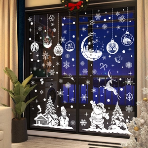 White Christmas window decals featuring Santa, reindeer and snowflakes on glass door