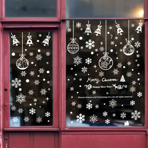 Detailed white Christmas window stickers featuring snowflakes and reindeer on glass