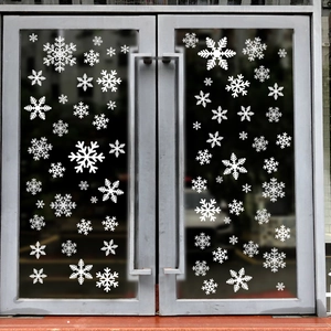 Detailed view of white snowflake static window stickers on glass doors for Christmas decor