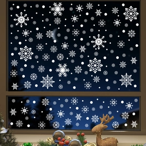 Close-up of white snowflake window clings on a glass pane for Christmas decor