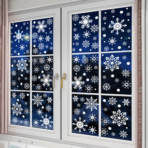 Detailed view of white snowflake static window decals in various sizes for winter decor