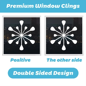 Detailed comparison of double-sided snowflake window stickers on a dark glass surface