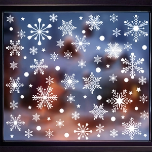Detail of white snowflake window clings with stars for Christmas glass decoration