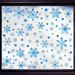 Close-up of blue snowflake static window stickers with glitter finish on frosted glass