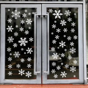 White snowflake static glass decals set on a modern glass door for Christmas decor