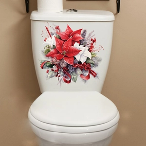 Macro detail of festive Christmas poinsettia stickers on a white ceramic toilet tank
