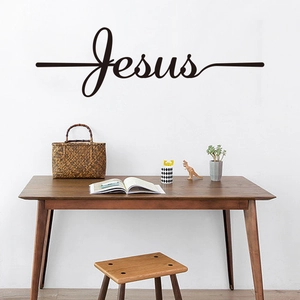 Minimalist black Jesus calligraphy wall sticker above a wooden desk for home decor