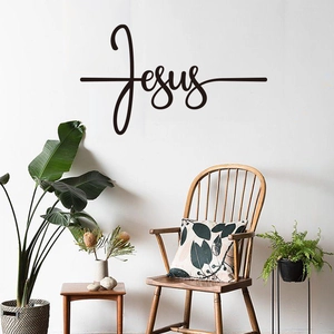 Minimalist black Jesus wall decal with cross design applied on a modern white living room wall