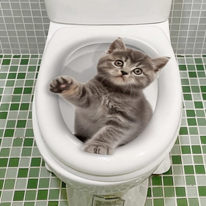 3D British Shorthair cat sticker on white toilet lid with green mosaic tile background