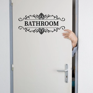 Self-adhesive black Bathroom door sticker with elegant scroll patterns on white door