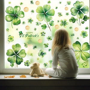 Detail of St. Patrick's Day window decals with green shamrocks and watercolor coins
