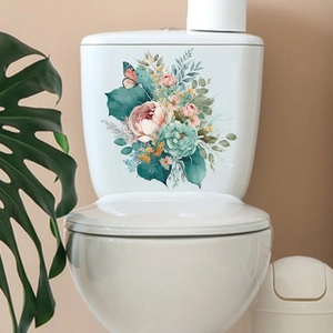 Detailed view of hand-painted floral and butterfly decals on a white ceramic toilet tank
