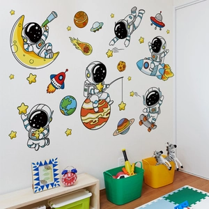 Detailed view of cartoon astronaut wall stickers in a decorated children's bedroom setting