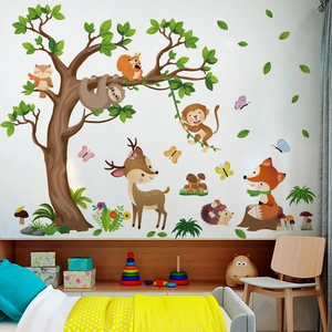 Detail of forest animal wall decals featuring trees, sloths and foxes in a kids bedroom