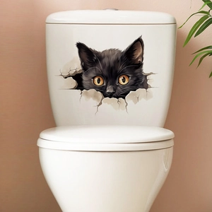 Detail of 3D black cat wall sticker appearing from a cracked hole on white toilet tank