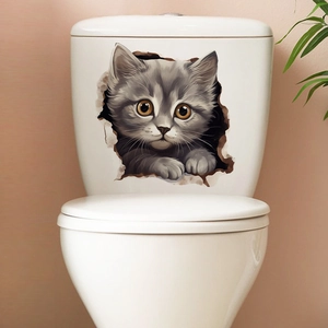 Detailed view of a 3D gray tabby cat wall sticker applied to a white ceramic toilet tank