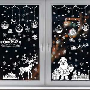 White Christmas window decals with Santa, reindeer and snowflakes on a glass window
