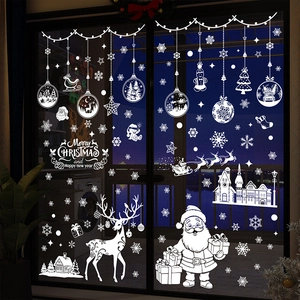White Christmas window decals with Santa, reindeer and snowflakes on a glass door