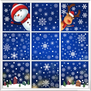 Christmas window decals with Santa, snowman and reindeer in a snowy winter village scene