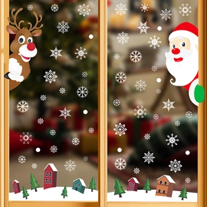 Detail of Christmas window clings showing Santa, reindeer and snowflakes on glass surface
