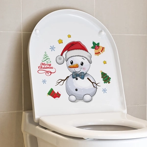 Detailed view of Merry Christmas snowman sticker applied on a white ceramic toilet lid